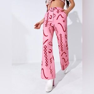 Pink graphic print boot cut pants with pockets